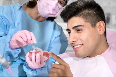man looking at aligners