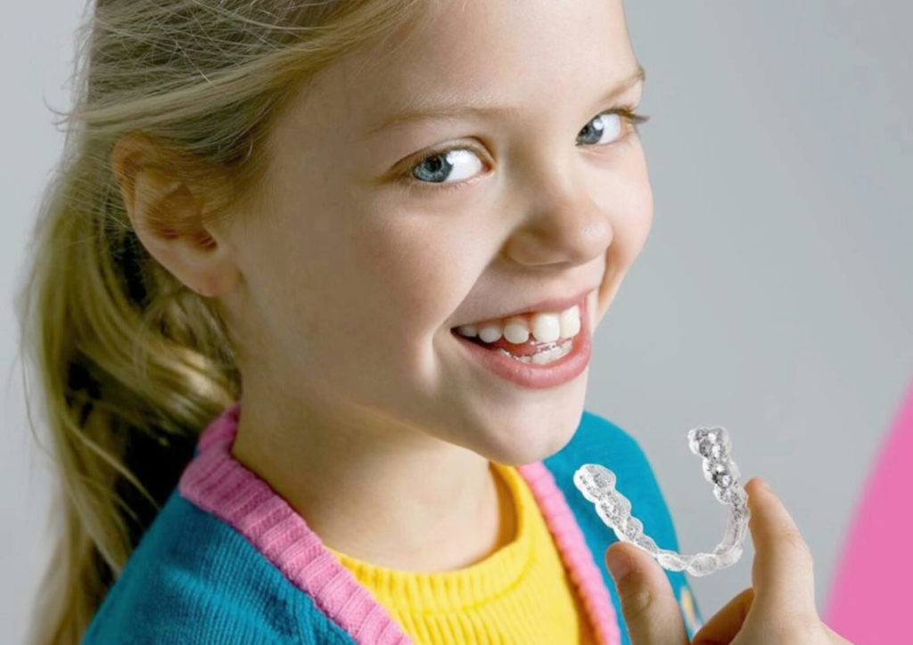 young girl with clear aligners