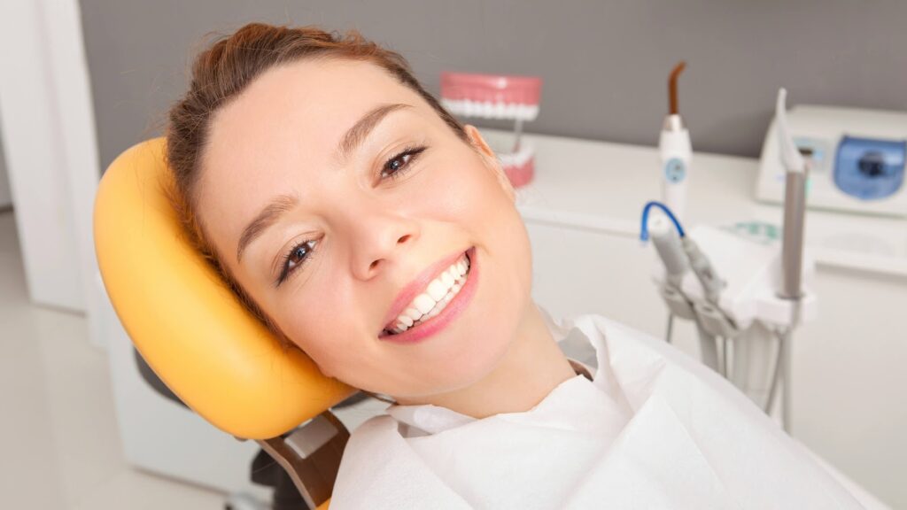 Happy patient after successful treatment of gingivitis and periodontal disease treatment at the dentist.