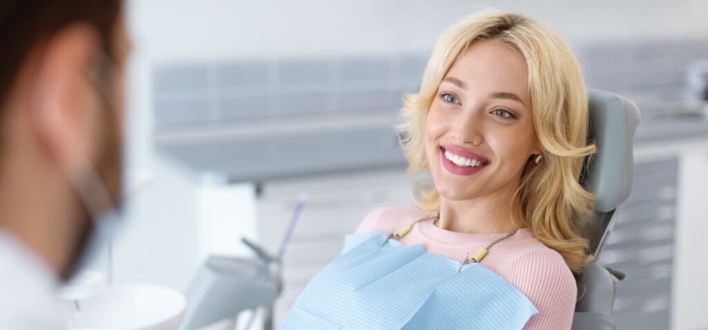 A beautiful smiling girl at oral and maxillofacial surgeon's office after her dental oral surgery.