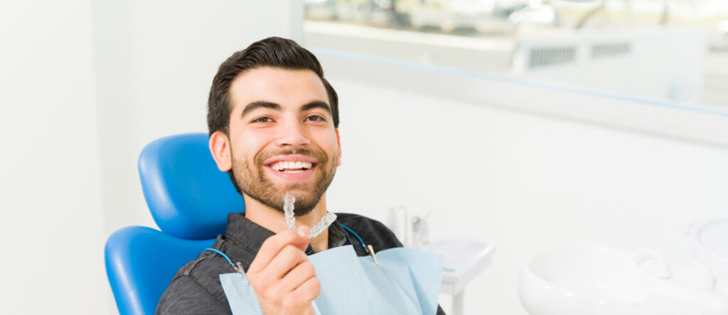 Man highlighting the Invisalign price, how much Invisalign costs, and whether Invisalign is cheaper than braces.