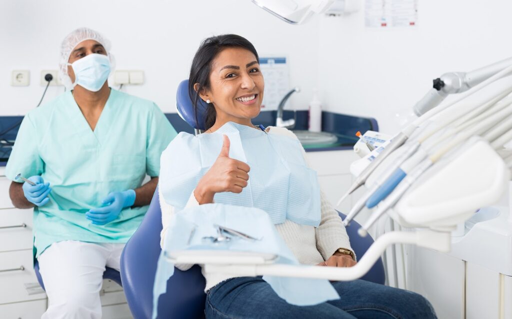 A happy patient after discussing Invisalign cost, how much Invisalign costs, and if Invisalign is cheaper than braces.