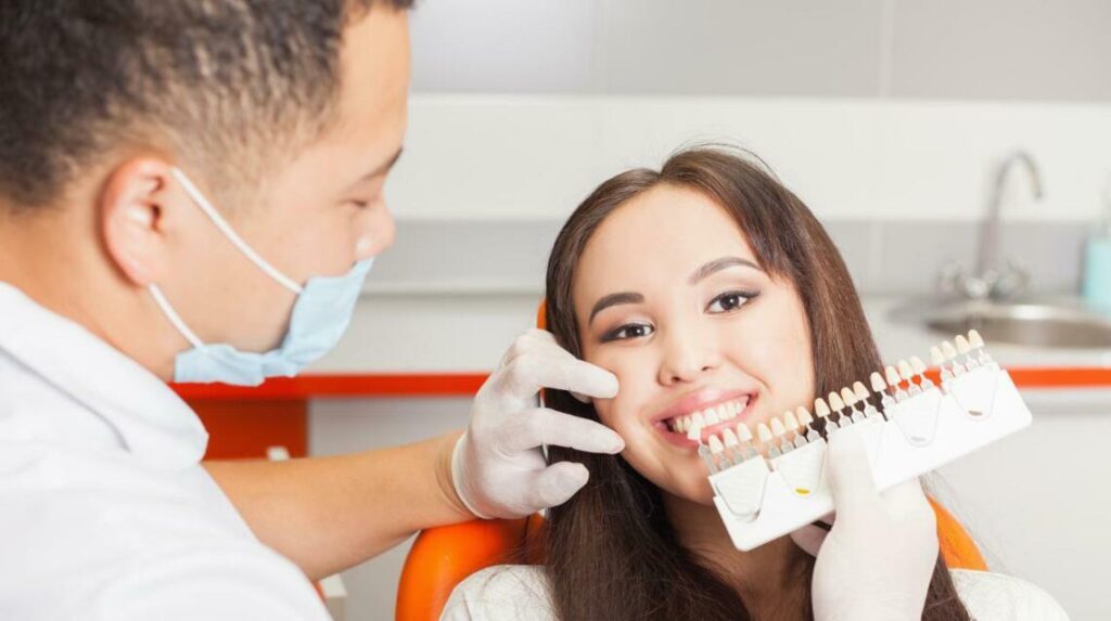 A happy patient at an orthodontist appointment, exploring the best orthodontics options for her patient.