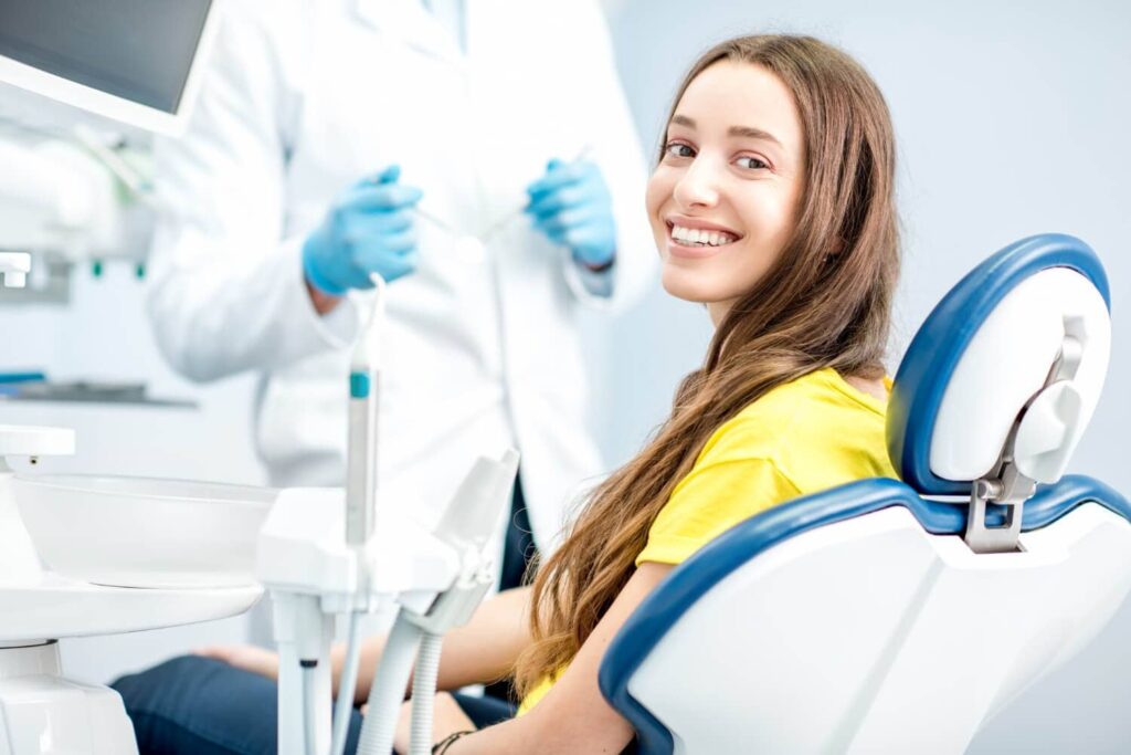 A beautiful girl visiting top-quality dental care near her for a beautiful smile using accelerated orthodontics.