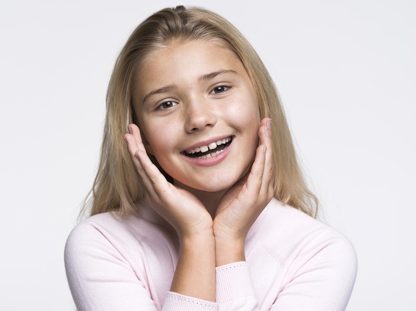 A Happy Teen showing results of braces for teens, Invisalign teen options, and teeth braces.